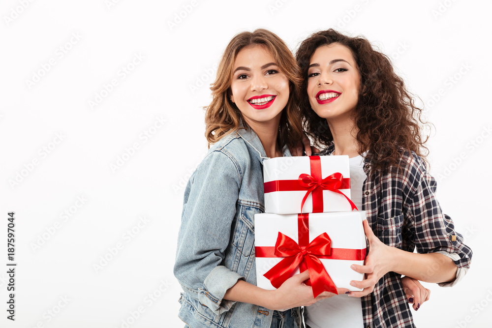 Image of Two smiling girls posing with gifts Image of Two smiling girls posing with gifts