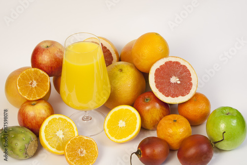 Exotic fruits and juice on a white background