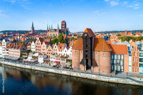 Gdansk old town in Poland with the oldest medieval port crane (Zuraw) in Europe, St Mary church, town hall tower and Motlawa River. Aerial view, early morning