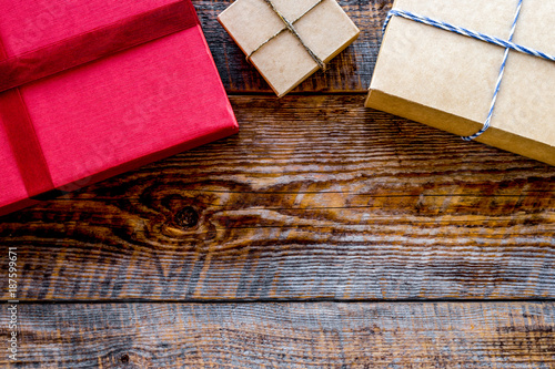 Colored gift boxes on wooden background top view copyspace