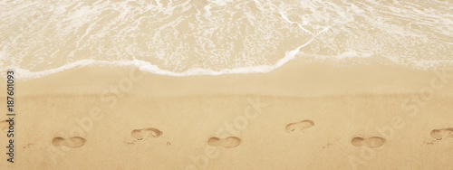 Trail shoes on the san. Surf on the beach. Sea shore