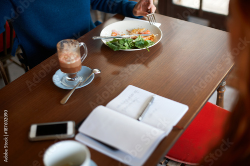 Cropped view of customer dining in cafe photo