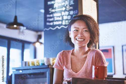 Happy woman in cafe, Shanghai French Concession, Shanghai, China photo