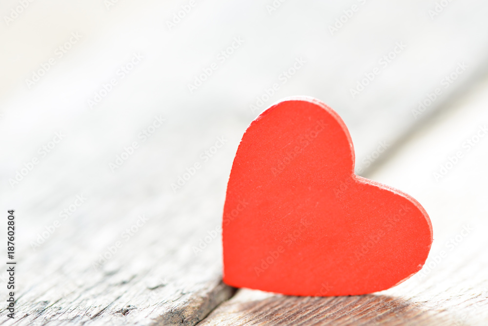 Fototapeta premium Heart on a wooden background. Background in the style of Valentine's Day. Heart on a wooden background.