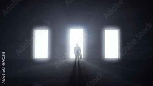 Man standing at three opening glowing doors in darkness, light rays coming trough. Decision concept