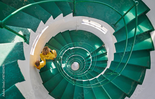 Overhead view of mother and son on spiral staircase, Tavares, Rio Grande do Sul, Brazil, South America photo