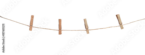 Four wooden clothespins on a rope, isolated on white background photo
