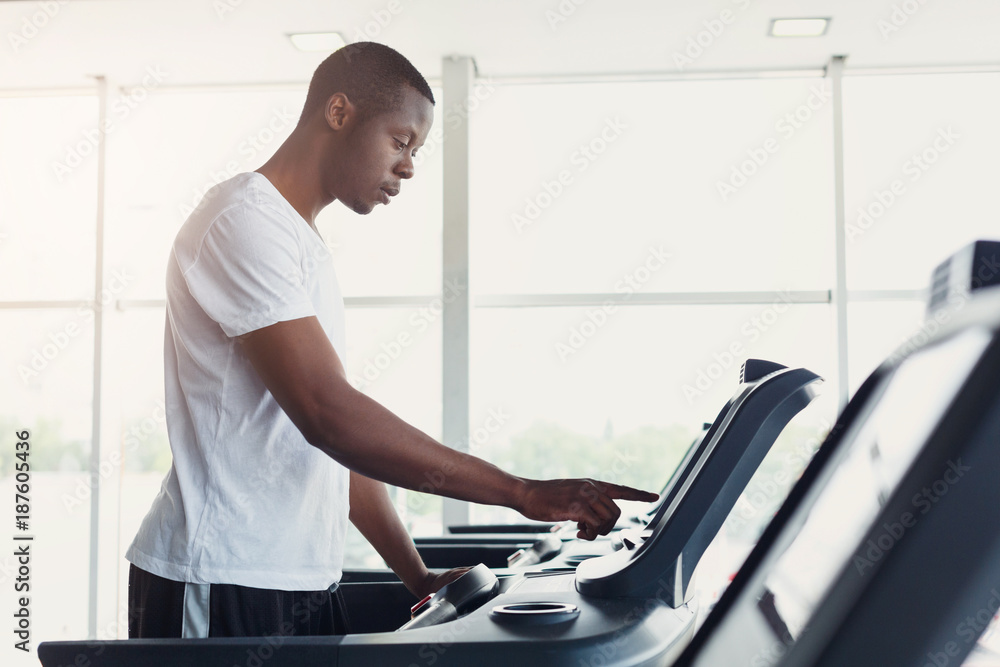 Young man in gym run on treadmill Young man in gym run on treadmill