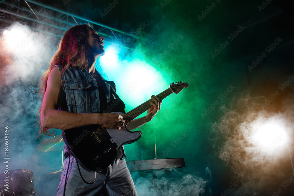 The guitarist performs on stage.
