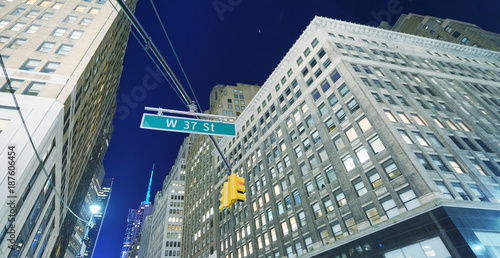 Street level view of New York skyscrapers at sunset