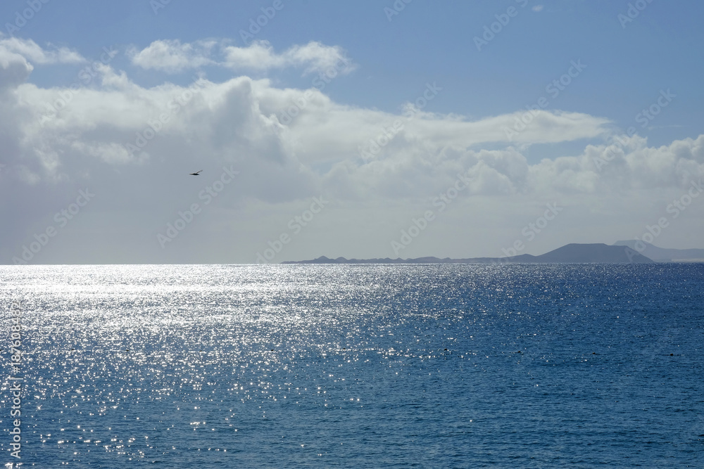 Fototapeta premium View on the ocean and the Canary islands Fuerteventura and Lobos.