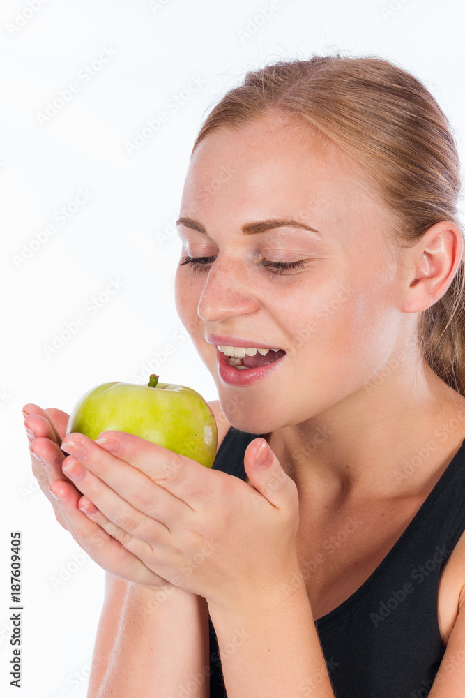 Young smiling girl with a green apple in her hand Young smiling girl with a green apple in her hand