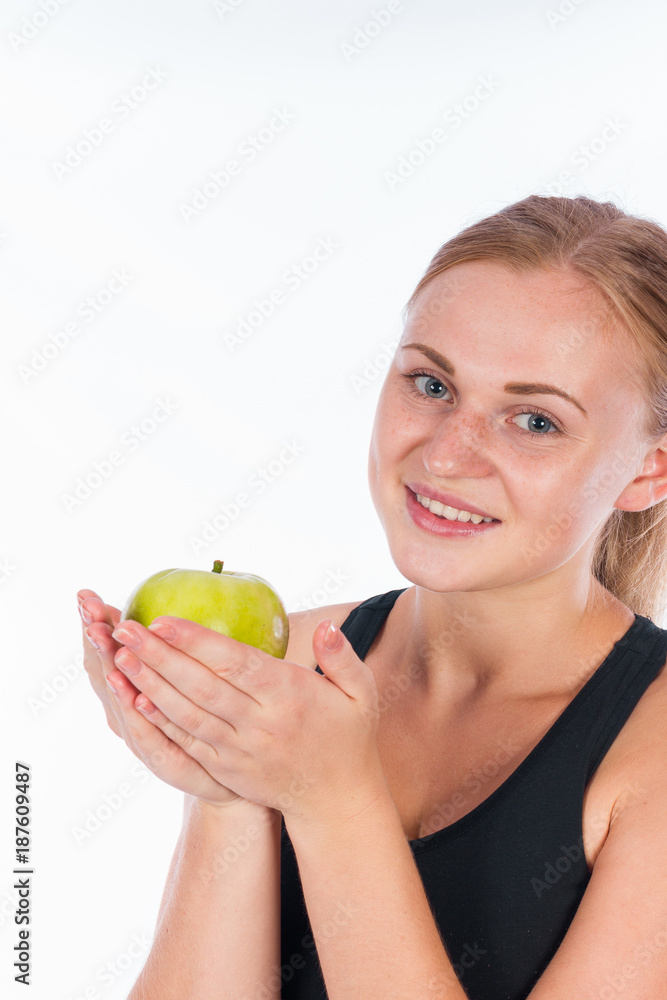 Young smiling girl with a green apple in her hand Young smiling girl with a green apple in her hand