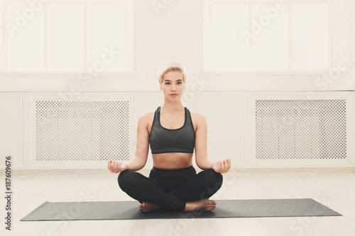 Young woman in yoga class, relax meditation pose