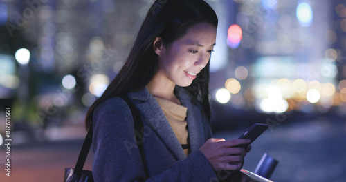 Asian Woman use of smart phone in city at night