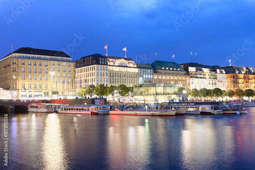 HAMBURG  GERMANY - JULY 20  2016  City skyline reflections on the lake at night. Hamburg attracts 10 million people annually