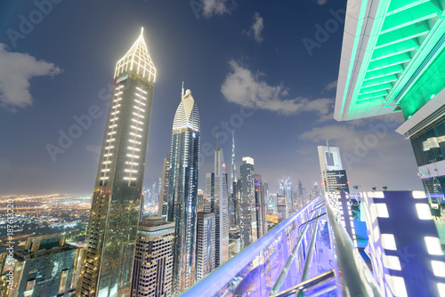 DUBAI, UAE - DECEMBER 11, 2016: Downrtown skyline along Sheikh Zayed Road at night as seen from rooftop. The city attracts 30 million tourists annually photo