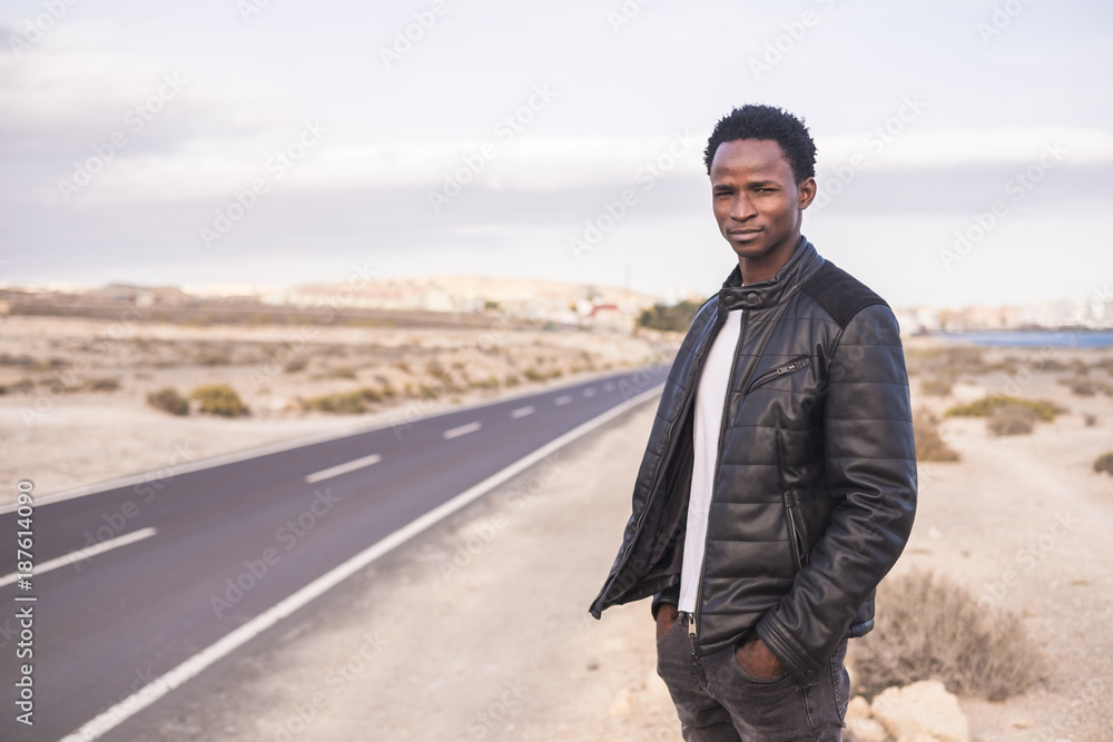 Spain, Tenerife, young man standing on road Spain, Tenerife, young man standing on road