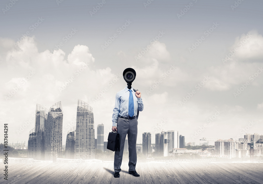Camera headed man standing on wooden floor against modern citysc Camera headed man standing on wooden floor against modern citysc