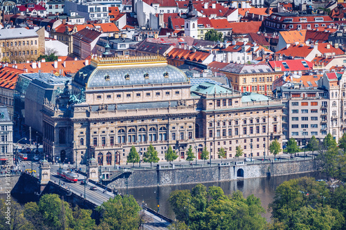 View of the Prague National Theater on a bright sunny day along the Vltava River, Czech Republic