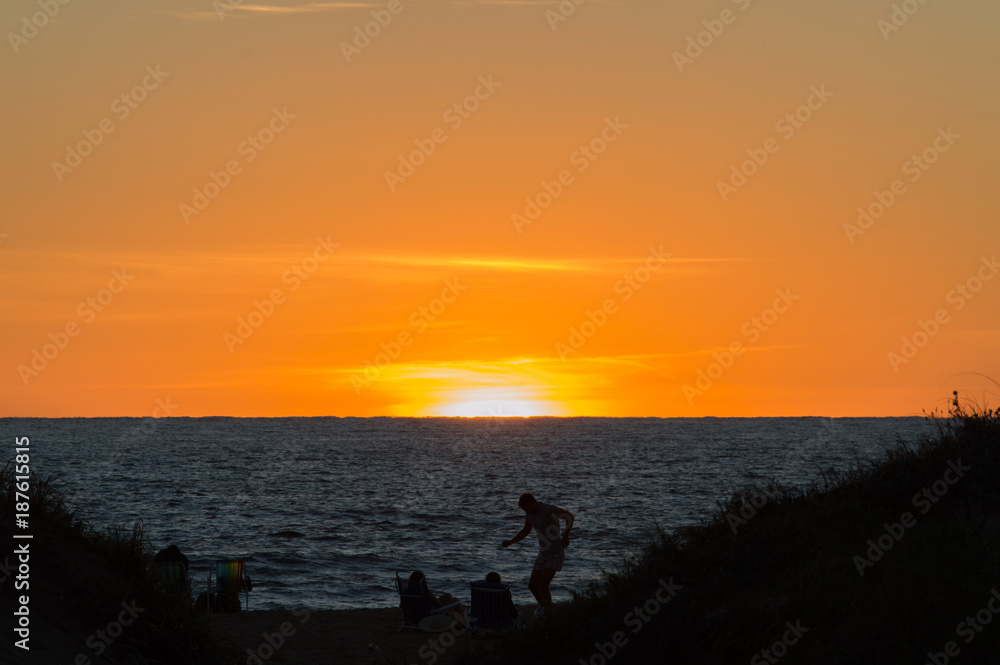silhouettes on the beach watching the sunset in Punta del Este, Uruguay