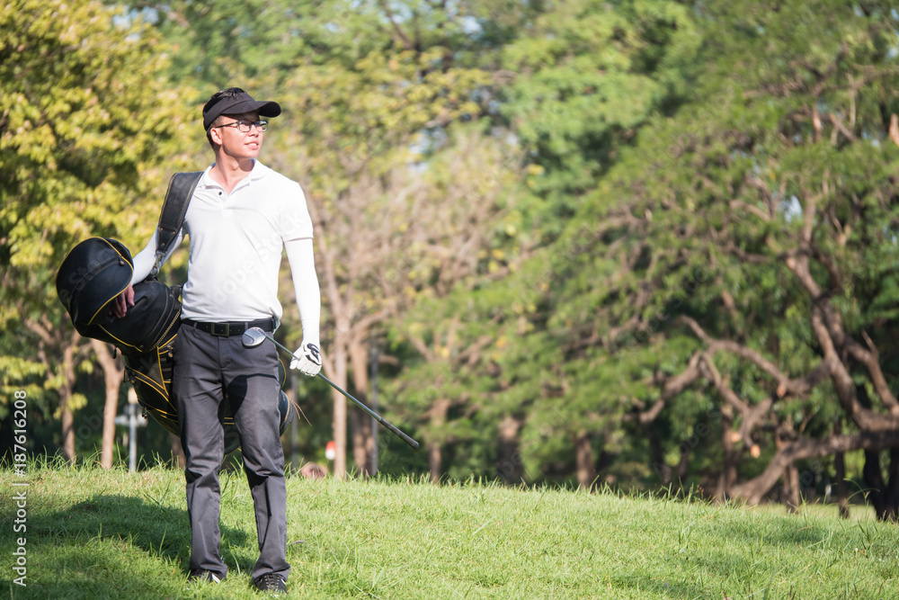 Portrait of asian young male golfer with golf club bag on the golf course. Portrait of asian young male golfer with golf club bag on the golf course.