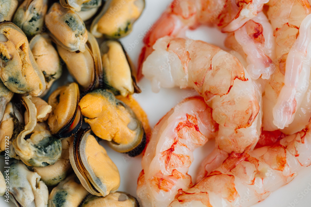 Mussels and prawns on white plate. Healthy Seafood Mussels and prawns on white plate. Healthy Seafood