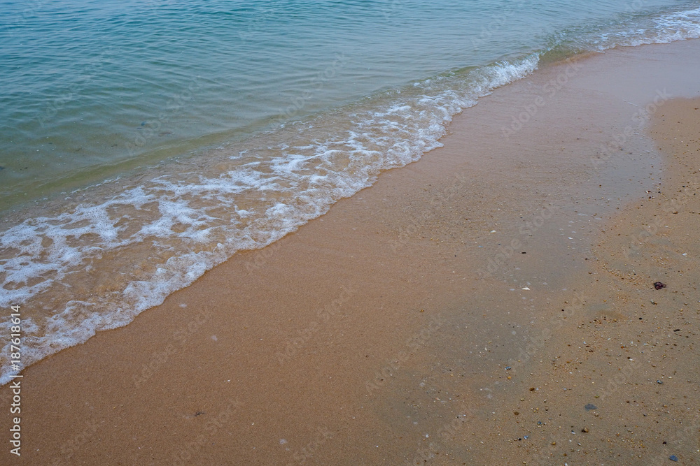 Wave of the sea on the sand beach.