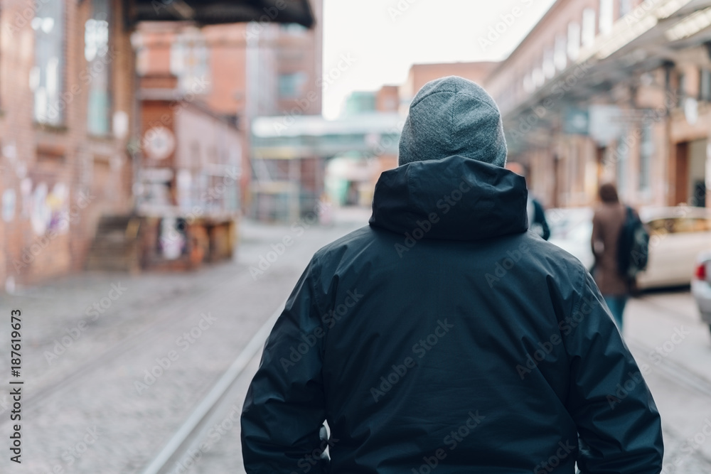 Rear view of a man wearing black insulated jacket Rear view of a man wearing black insulated jacket