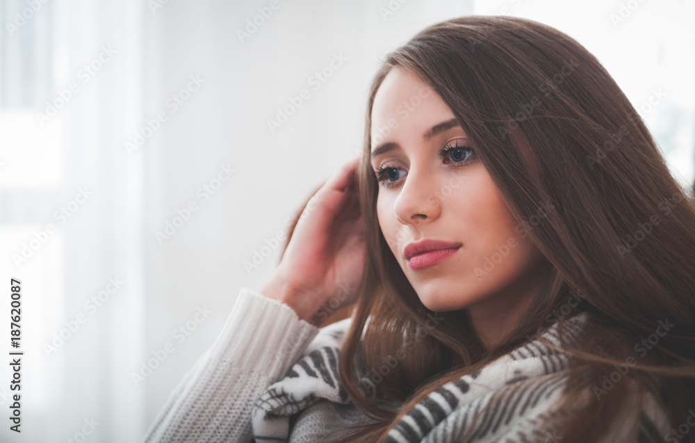 Woman at home sitting on chair and thinking about something Woman at home sitting on chair and thinking about something