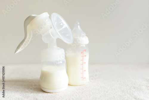 Breast pump and bottle with milk for baby