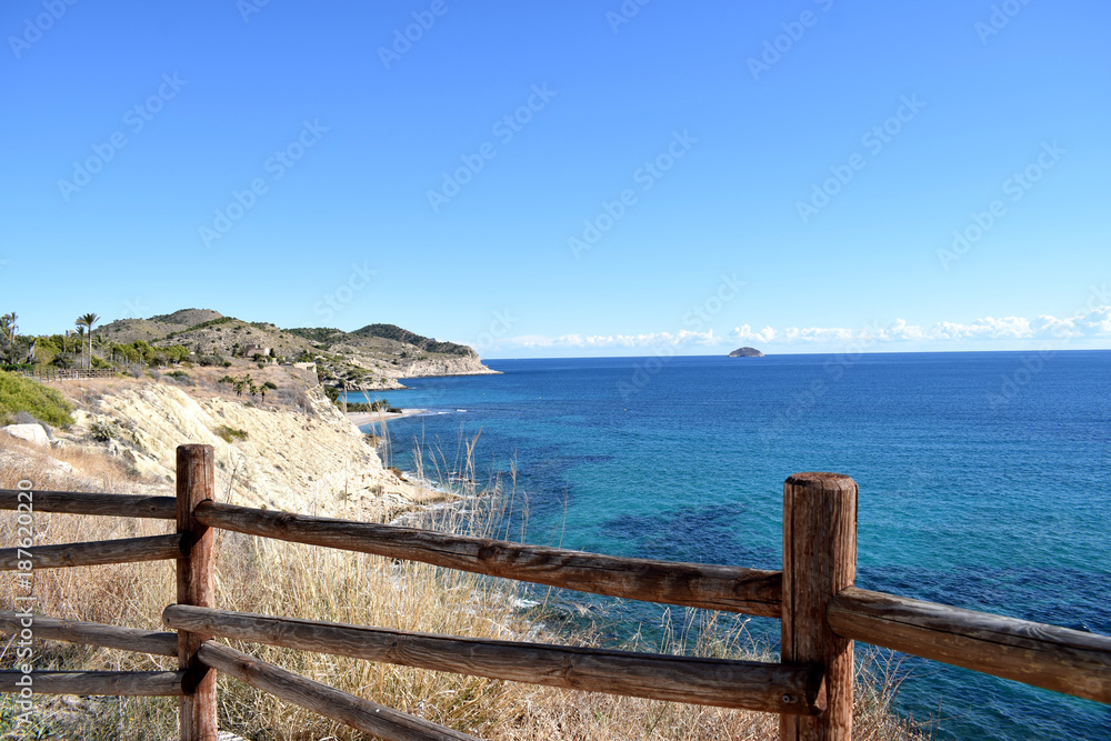 View through the wooden fence on spanish sea coast View through the wooden fence on spanish sea coast