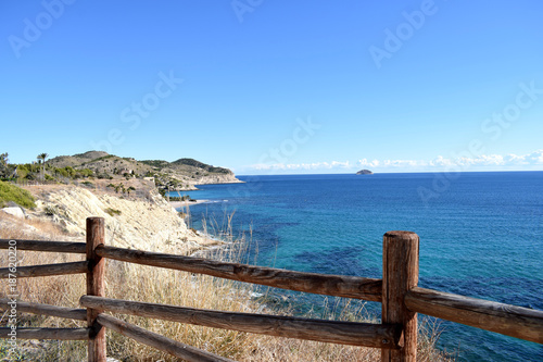 View through the wooden fence on spanish sea coast