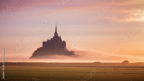 Beautiful panoramic view of famous Le Mont Saint-Michel tidal island at sunrise. Normandy, northern France photo