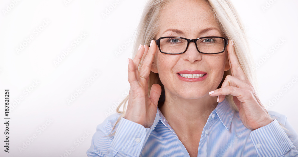 Middle aged business woman with eyeglasses in blue shirt isolated on white background Middle aged business woman with eyeglasses in blue shirt isolated on white background