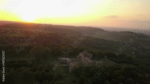 Aerial footage of summer sunset above the Pidhirtsi Castle in general shot with green forest and fields (4K, 25fps)