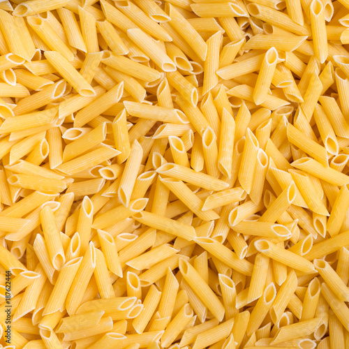 yellow dry penne pasta background
