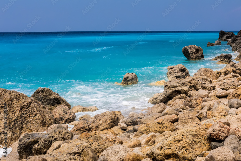 Sea waves crashing on rocks at the Megali Petra Beach in Lefkada Island, Greece