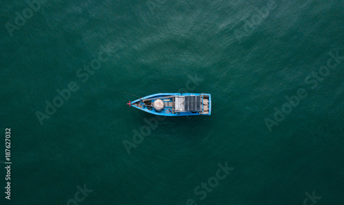 old fishing boad on the open sea, drone shot from above, amazing boat photography