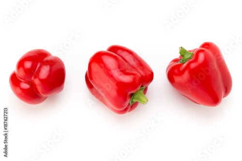 Red bell pepper with half and leaves isolated on white. © gitusik