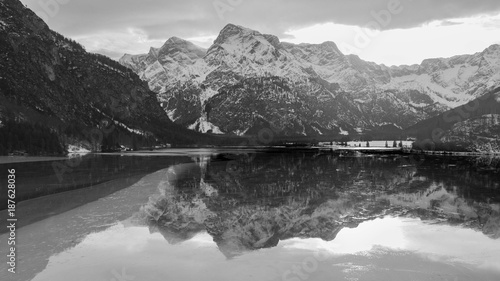 winter time in austria, snow on the alps of austria, huge mountain with snow on it, black and white shot