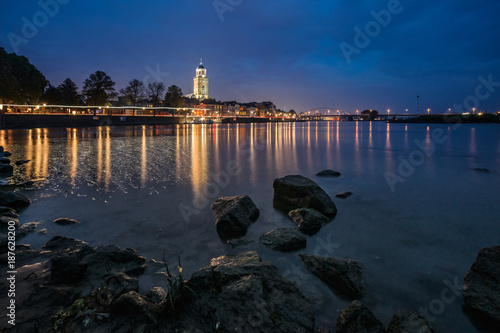 An evening scene of a river landscape in the Netherlands at the town of Deventer
