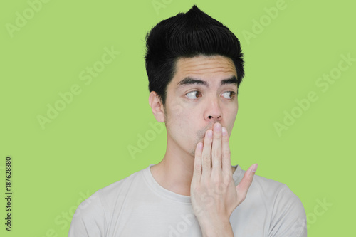 Close-up Handsome young asian man excited isolated on green background.Copy space. Human Face.