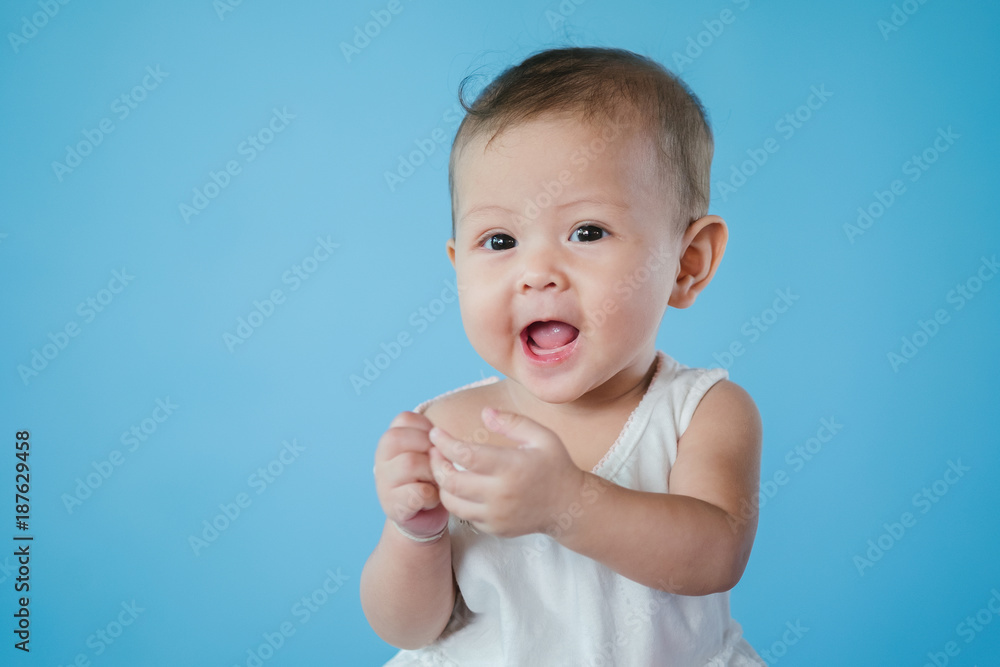 Cute happy smiling baby on blue background. isolated. asia baby. Cute happy smiling baby on blue background. isolated. asia baby.