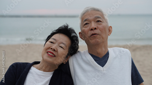 Asian senior couple enjoy their life time together at the sea