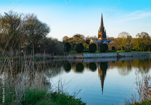 Church reflecting in lake at Clumber Park, a National Trust estate in Nottinghamshire, UK