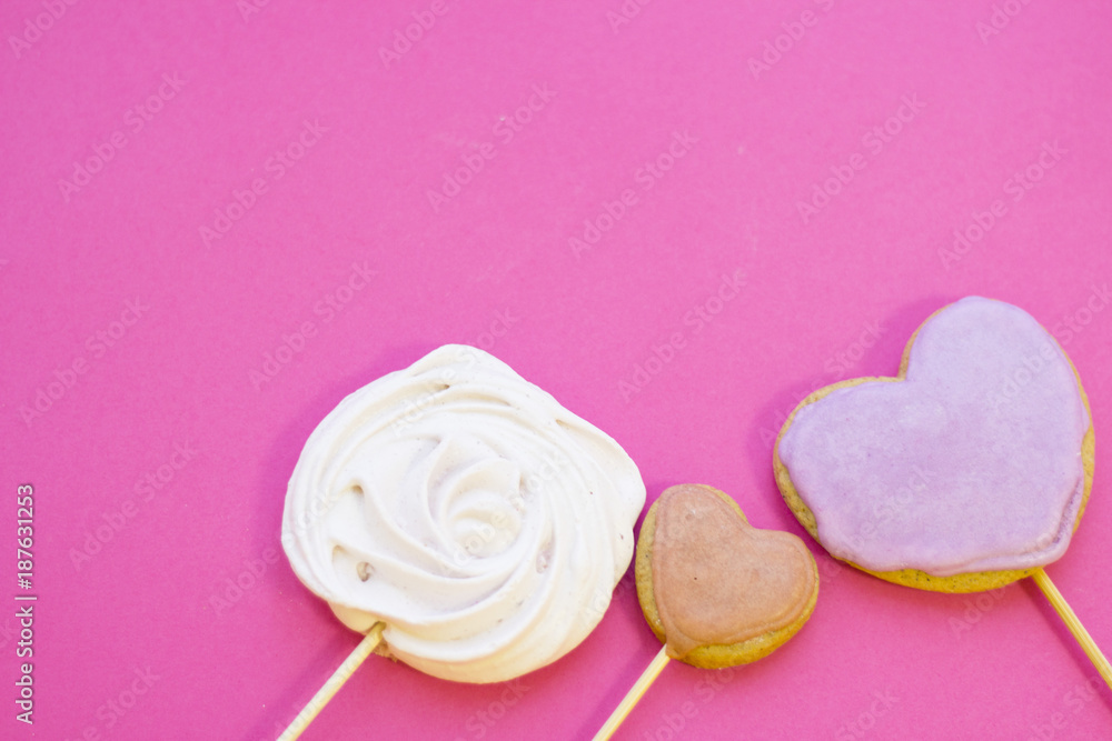 St. Valentine's Day or Anniversary concept with sweets and ginger cookies, pink background, top view St. Valentine's Day or Anniversary concept with sweets and ginger cookies, pink background, top view