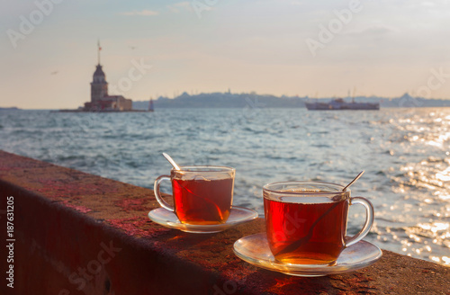 A cup of Turkish tea on the background of the Maiden Tower photo