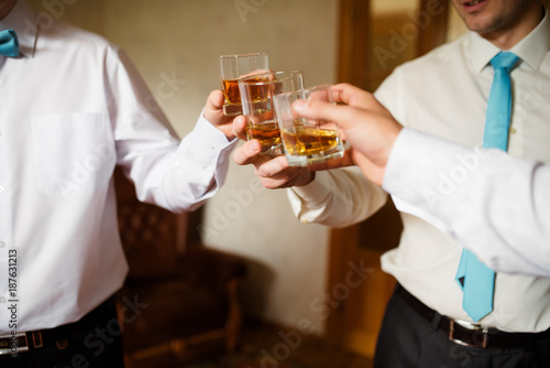 Men celebrating and drinking cognac.