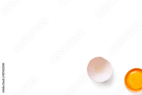 fresh brown organic chicken egg broken with yolk and egg white isolated on white background. Horizontal composition. Top view
